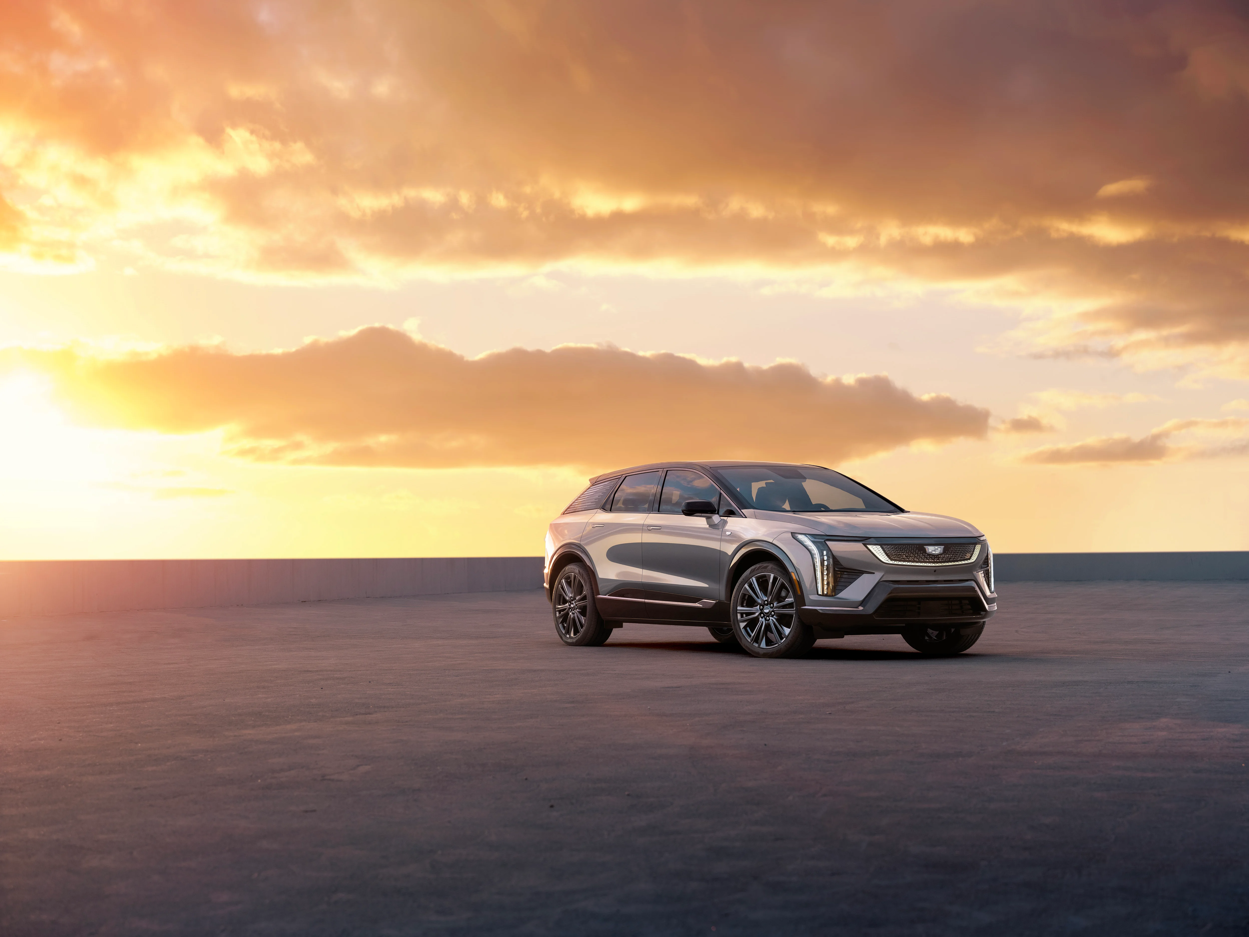 2025 cadillac optiq in front of a sunset