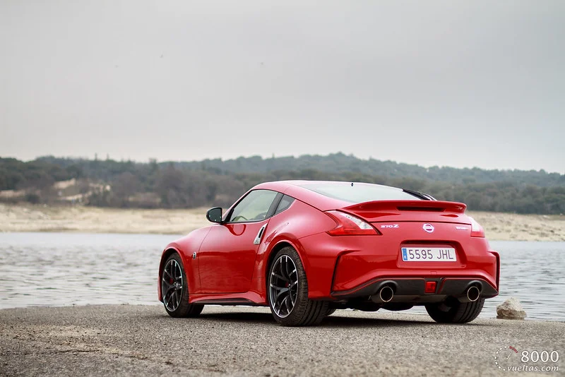 Red Nissan 370Z by a lake