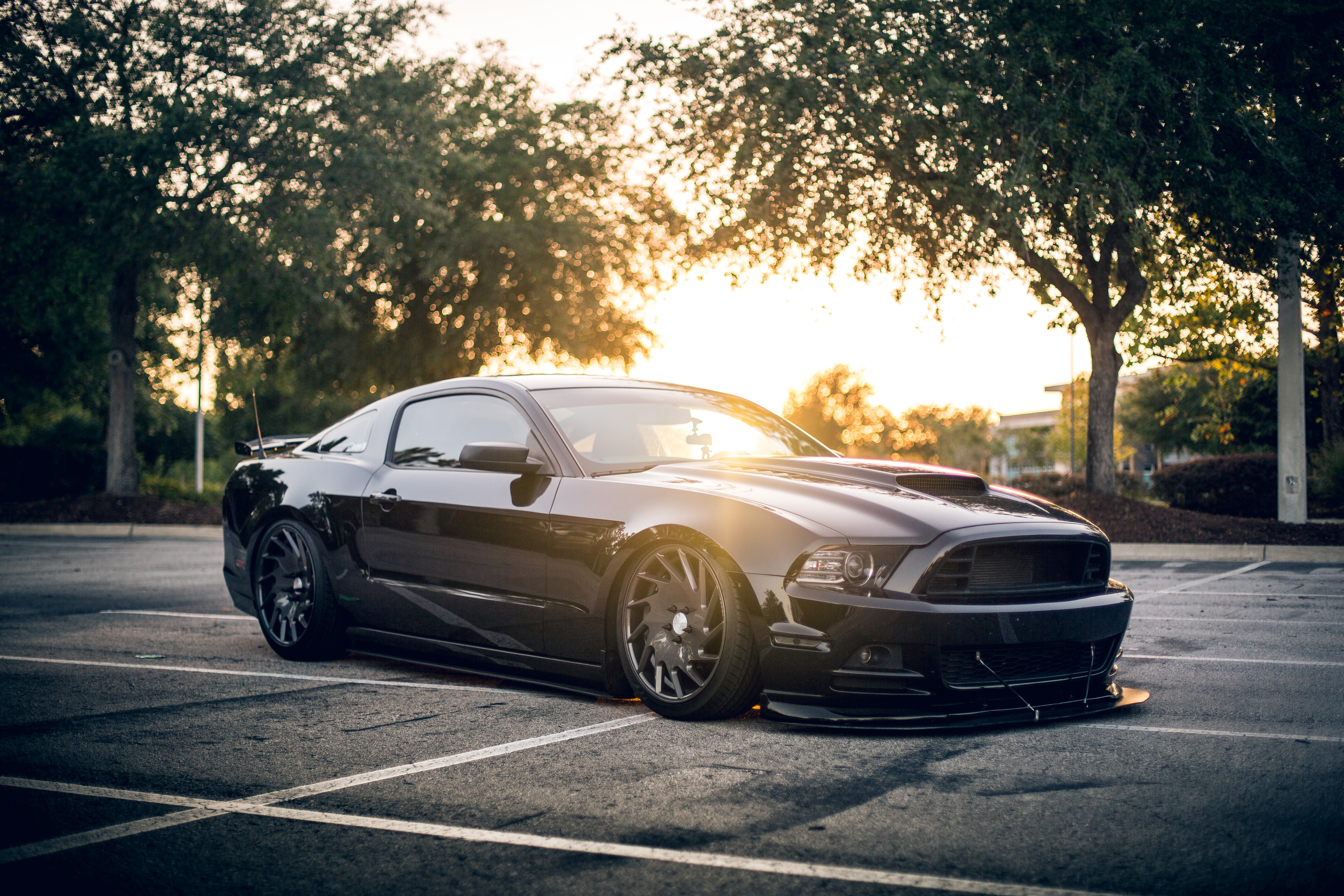 a black sports car parked in a parking lot