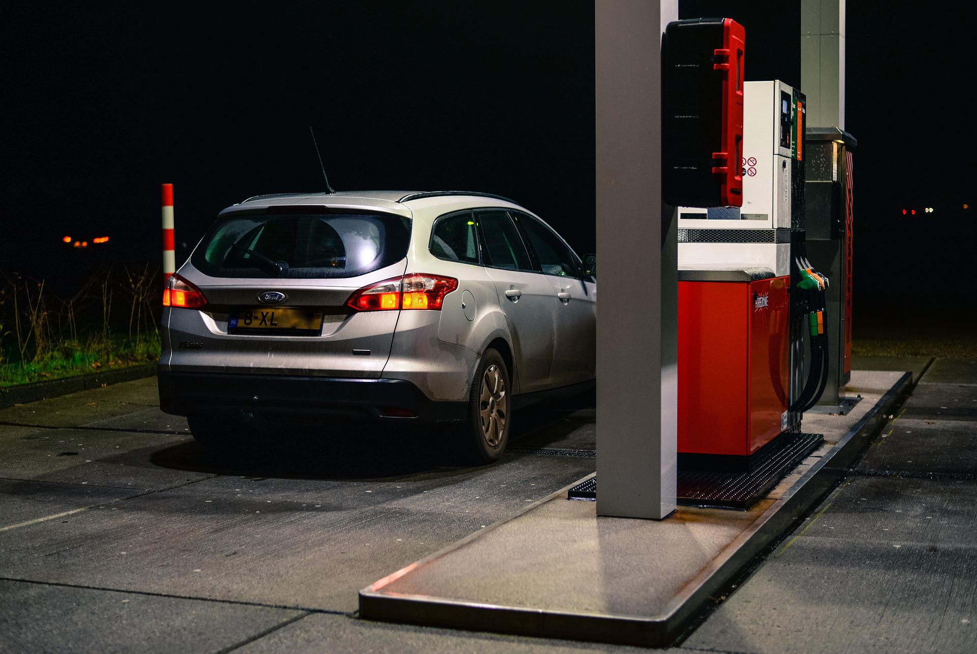 car at gas station pump