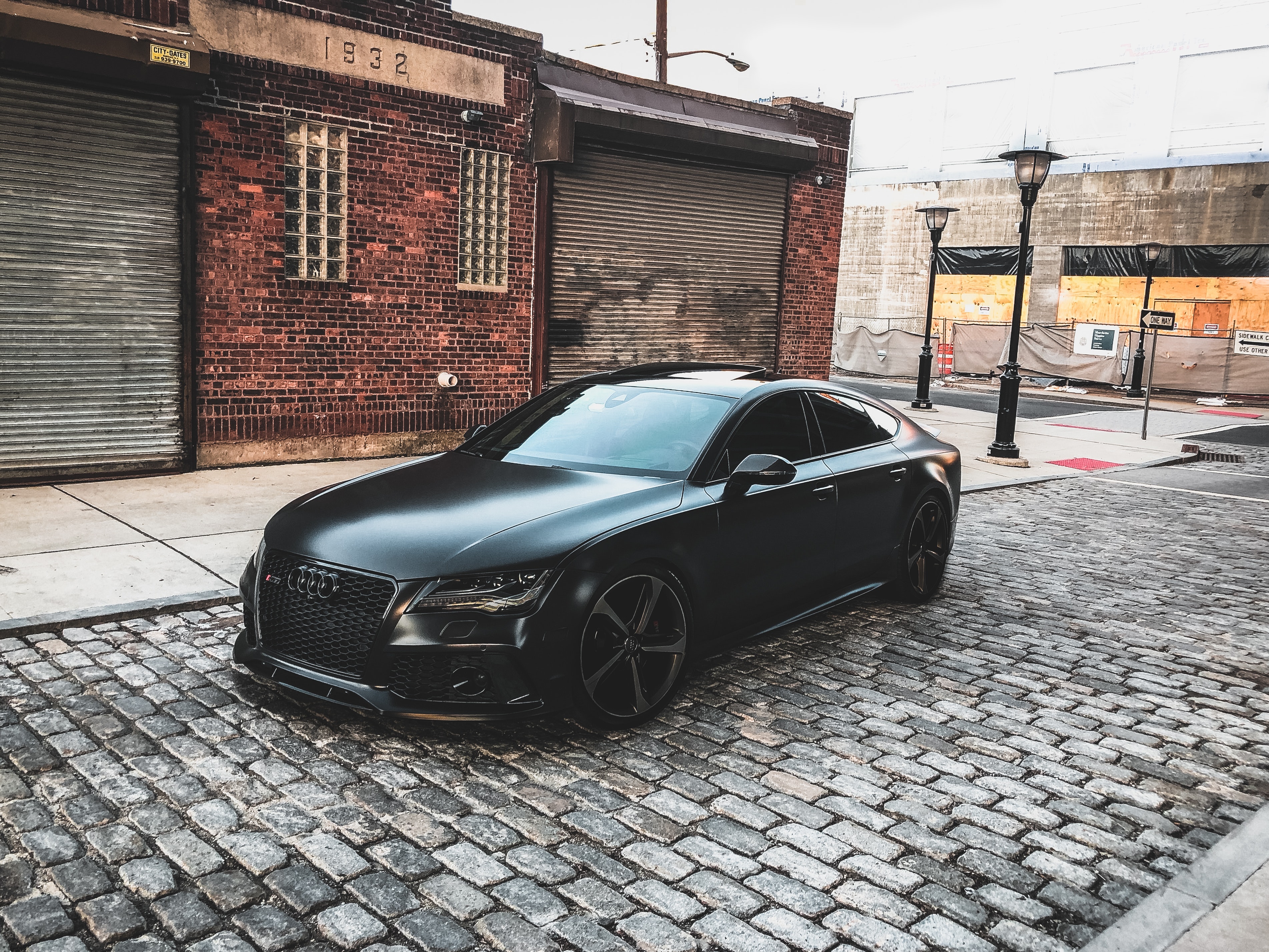 black audi driving on cobblestones